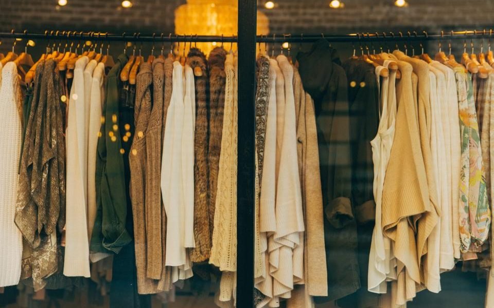 Rail of clothes in neutral beige, brown and cream tones