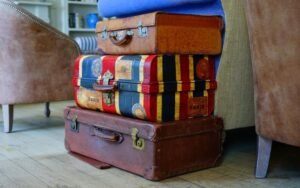 Stack of colorful vintage suitcases next to an armchair