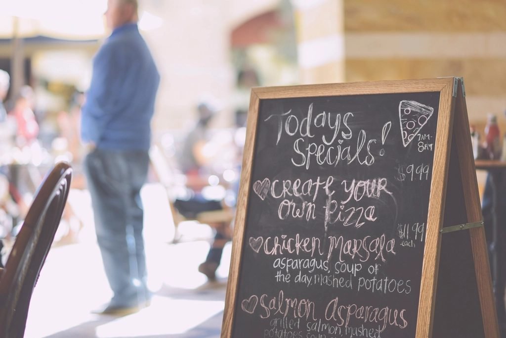 Chalkboard sign listing the day's specials outside a restaurant