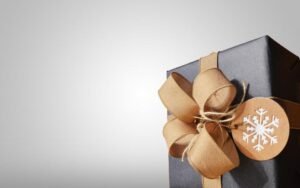 Black gift box tied with a kraft paper bow