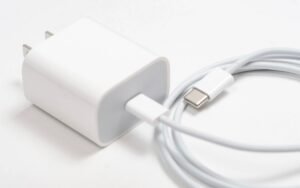 White phone charger with a coiled USB-C cable