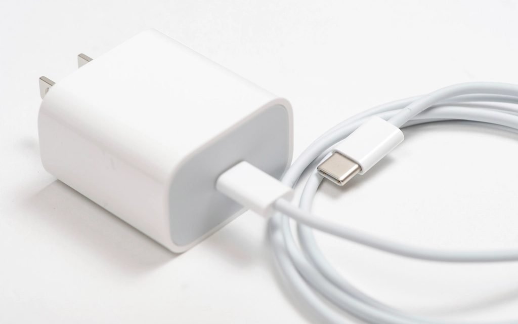 White phone charger with a coiled USB-C cable