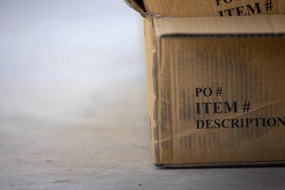 Cardboard shipping box with item and description labels