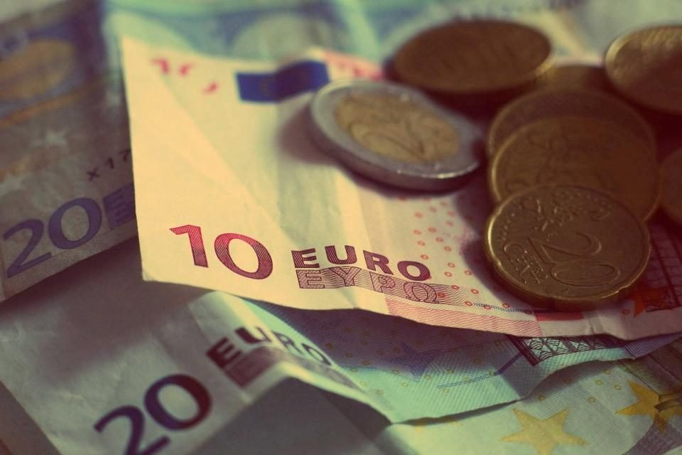 Euro banknotes and coins on a table